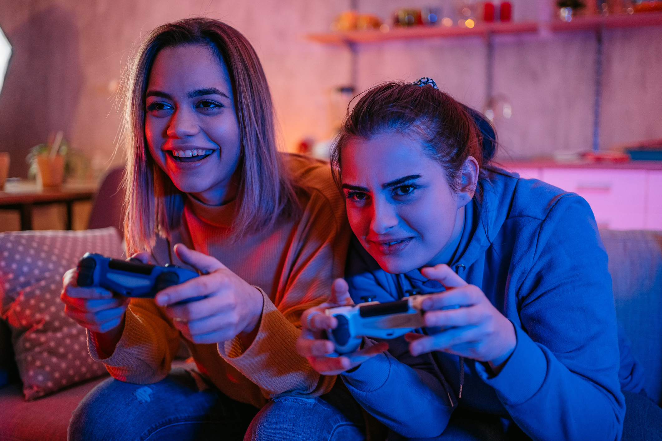 Two young women playing video games together